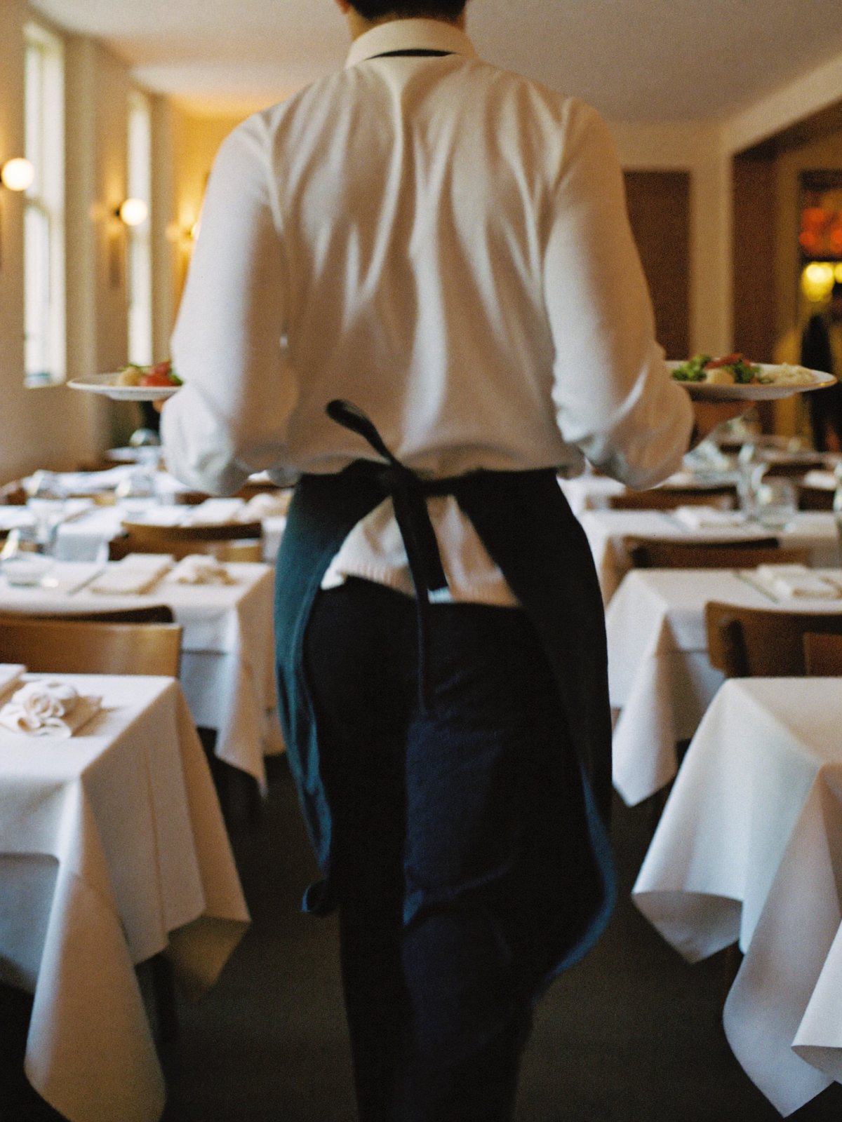 Waiter taking an order at a table with a handheld