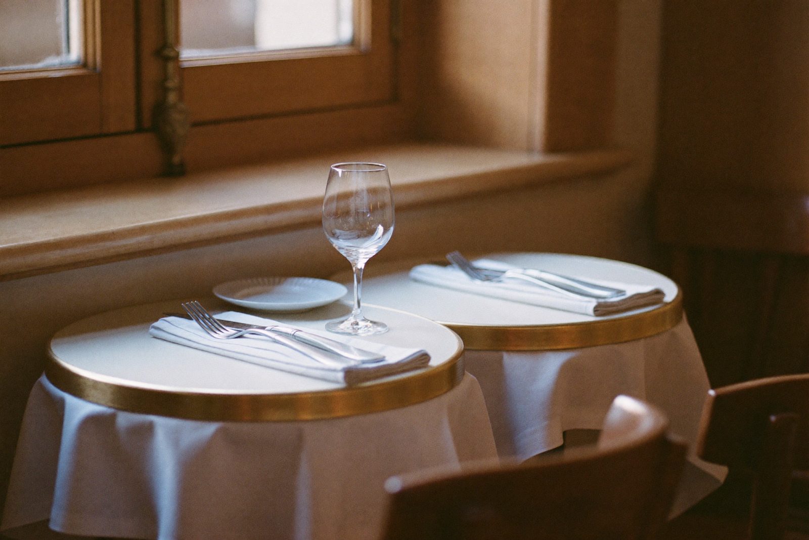 Host taking a reservation at the door of a full dining room